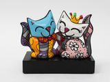 two figurines of cats sitting next to each other