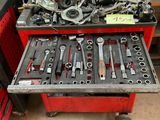 many tools in a red tool box on a table
