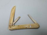 a small knife with a wooden handle on a table