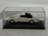a small white car in a clear box on a table