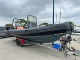 a boat that is sitting on a trailer in the parking lot