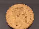 an image of a gold coin with a man ' s face on it