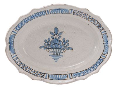 a blue and white plate with a flower design on it
