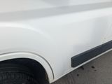 a close up of a white truck with a black door handle