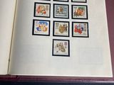 an open book with stamps on it sitting on a table