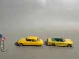 two toy cars that are sitting next to each other