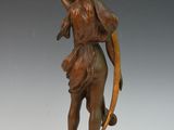 bronze statue of a woman with a bow and arrow in her hand