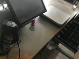 a desk with a monitor and a printer on it