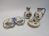 four pieces of porcelain on a white table
