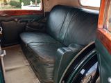 a black leather couch sitting in the back of a car