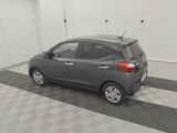 a picture of a grey car parked in a garage