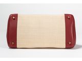 a red and white purse with a stripe design on the front
