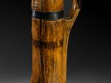 an image of a wooden vase with a handle on a table