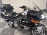 motorcycle parked on a checkered tile floor in a garage