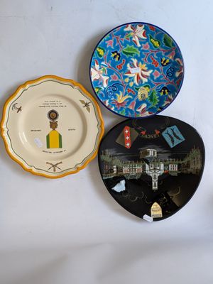 three plates on the wall with a picture on them