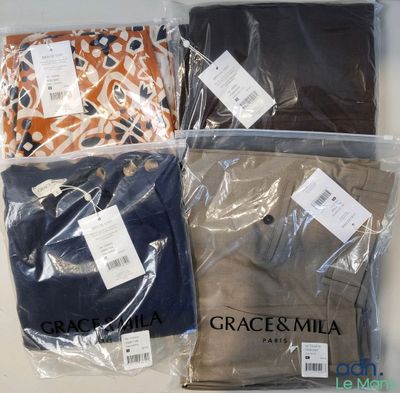 four pieces of clothing are wrapped in plastic bags on a table