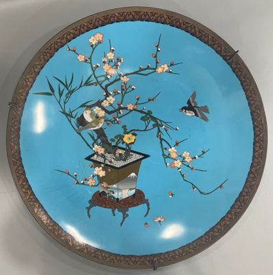 a blue plate with flowers and birds on it