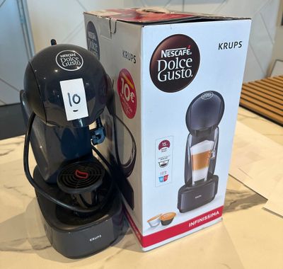 a box of coffee on a table next to a coffee maker