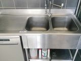 a stainless steel sink and a dishwasher in a kitchen
