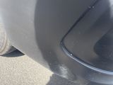 a close up of a car ' s front bumper and tire
