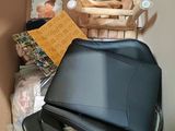 a box with a chair, a chair, a book, and other items in it