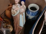 a statue of jesus holding a child in a box