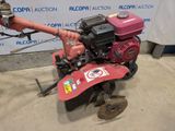 an image of a small lawn mower being used by a man