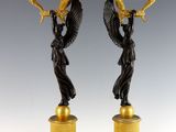 pair of antique bronze figurines of angels on pedestals