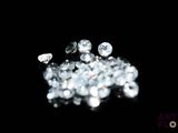 a pile of diamonds on a black surface