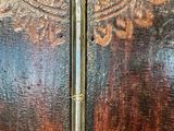 a close up of a clock on a wooden wall