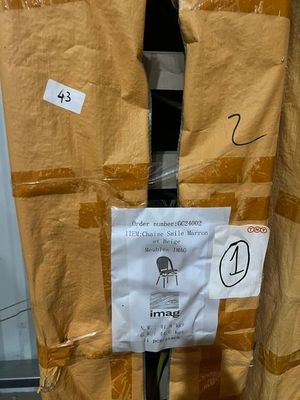 a cardboard box with a sign on it and a pair of skis attached to it