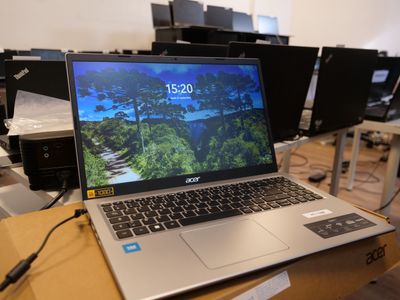 a laptop that is sitting on a table in front of a bunch of computers