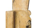 an old wooden sculpture of a man ' s head on a white background