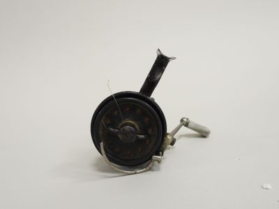 a close up of a small metal object on a white surface