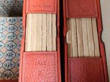 two books in a red box on a table