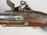 an old gun with a wooden body and metal parts on a white surface