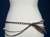 a close up of a mannequin torso with a chain belt around it