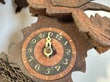 a clock that has a bird on it and a bird on it