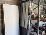 an image of a garage with a refrigerator and shelves