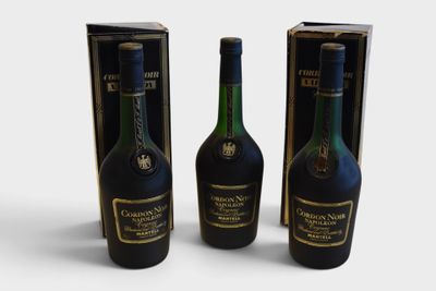 three bottles of wine sitting next to each other on a white surface