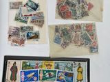 a lot of stamps on the table and a wallet