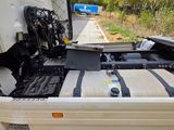 a white truck with a black stripe on the back of it
