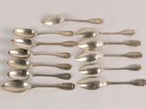 six silver spoons are arranged in a row on a white surface
