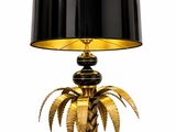 a black and gold palm tree lamp with a black shade