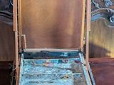 a wooden box with a painting on it sitting on a table
