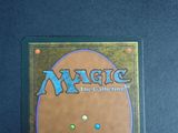 a close up of a card on a table with a blue background