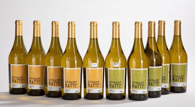 six bottles of white wine are lined up in a row