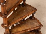 an image of a wooden spiral staircase with three shelves on each side
