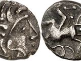 a silver coin with an image of a bird on it