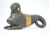 a statue of a woman laying on the ground next to a statue of a lion